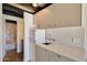 Small galley kitchen with white cabinets and retro refrigerator at 1308 E Gardenia Dr, Phoenix, AZ 85020