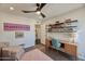 Home office with wood desk, shelving, and mid-century chair at 1308 E Gardenia Dr, Phoenix, AZ 85020