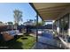 Covered patio with seating and lush green lawn at 1308 E Gardenia Dr, Phoenix, AZ 85020