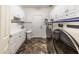 Bright laundry room with ample cabinet space and modern appliances at 13210 W Palo Verde Dr, Litchfield Park, AZ 85340