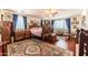 Main bedroom with hardwood floors and ornate wooden bed at 13210 W Palo Verde Dr, Litchfield Park, AZ 85340