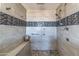 Large walk-in shower with tile surround and built-in seat at 13210 W Palo Verde Dr, Litchfield Park, AZ 85340