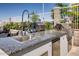 Granite-topped outdoor kitchen with grill, sink, and pizza oven at 140 E Rio Salado Pkwy # 1205, Tempe, AZ 85281