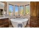 Spa-like bathroom featuring a freestanding tub and mountain views at 14179 E Kalil Dr, Scottsdale, AZ 85259