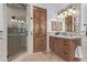 Bathroom with a walk-in shower and wood vanity at 14179 E Kalil Dr, Scottsdale, AZ 85259