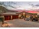 Beautiful home exterior at sunset with mountain views at 14179 E Kalil Dr, Scottsdale, AZ 85259