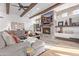 Cozy living room with a stone fireplace and built-in shelving at 14179 E Kalil Dr, Scottsdale, AZ 85259