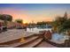 Stunning pool and spa with stone decking at sunset at 14179 E Kalil Dr, Scottsdale, AZ 85259