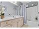 Bathroom with shower/tub combo, vanity, and gray shower curtain at 14300 W Bell Rd # 326, Surprise, AZ 85374