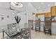 Dining area with glass table and chairs, adjacent to kitchen at 14300 W Bell Rd # 326, Surprise, AZ 85374