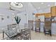 Bright dining area with glass table and four chairs, adjacent to kitchen at 14300 W Bell Rd # 326, Surprise, AZ 85374