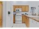 Well-equipped kitchen featuring wood cabinets, microwave, stove, and dishwasher at 14300 W Bell Rd # 326, Surprise, AZ 85374