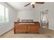 Spacious bedroom with wood bed frame and ceiling fan at 14353 W Ventura St, Surprise, AZ 85379