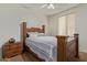 Bedroom with wooden bed frame and window coverings at 14353 W Ventura St, Surprise, AZ 85379