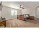 Bright bedroom with carpeted floors and wood bed frame at 14353 W Ventura St, Surprise, AZ 85379