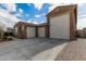 View of the home's exterior, including a large three-car garage at 14353 W Ventura St, Surprise, AZ 85379