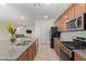 Spacious kitchen with stainless steel appliances and granite island at 14353 W Ventura St, Surprise, AZ 85379