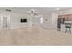 Open living room with tile floors and a view into the kitchen at 14353 W Ventura St, Surprise, AZ 85379