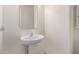 Small powder room with pedestal sink and mirror at 14353 W Ventura St, Surprise, AZ 85379