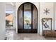 Grand entryway with an ornate iron door and tile flooring at 14521 E Desert Vista Trl, Scottsdale, AZ 85262