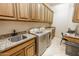 Spacious laundry room with built-in cabinets and granite countertops at 14521 E Desert Vista Trl, Scottsdale, AZ 85262