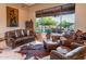 Secondary living area with leather furniture and views of the backyard at 14521 E Desert Vista Trl, Scottsdale, AZ 85262