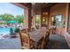 Covered patio with large wooden dining table, ideal for outdoor entertaining at 14521 E Desert Vista Trl, Scottsdale, AZ 85262