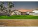 House with grassy backyard and large tree at sunset at 14821 N 60Th Dr, Glendale, AZ 85306