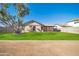 House with grassy backyard and large tree at 14821 N 60Th Dr, Glendale, AZ 85306