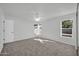 Well-lit bedroom featuring gray carpet and ceiling fan at 14821 N 60Th Dr, Glendale, AZ 85306