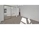 Bedroom with gray carpet, mirrored closet and a view of a bathroom at 14821 N 60Th Dr, Glendale, AZ 85306