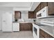 Galley kitchen with wood cabinets and white appliances at 14821 N 60Th Dr, Glendale, AZ 85306