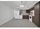 Kitchen with white appliances, wood cabinets, and a view into dining area at 14821 N 60Th Dr, Glendale, AZ 85306