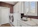 Laundry room with white cabinets, washer, dryer, and a quartz countertop at 15548 E Jojoba Ln, Fountain Hills, AZ 85268