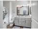 Bathroom with double vanity, large mirror, and walk-in shower at 16224 W La Ventilla Way, Goodyear, AZ 85338