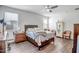 Main bedroom with a queen-size bed, dresser, and plenty of natural light at 16224 W La Ventilla Way, Goodyear, AZ 85338