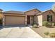 Single-story home with a two-car garage and landscaped front yard at 16224 W La Ventilla Way, Goodyear, AZ 85338