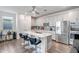 Modern kitchen with white cabinets and a large island at 16224 W La Ventilla Way, Goodyear, AZ 85338