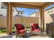 Relaxing covered patio with seating area, artificial turf, and grill at 16224 W La Ventilla Way, Goodyear, AZ 85338