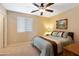 Cozy bedroom with ceiling fan, window coverings, and built-in shelving at 16225 N 22Nd Dr, Phoenix, AZ 85023