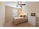 Bright bedroom with a ceiling fan and a white dresser at 16225 N 22Nd Dr, Phoenix, AZ 85023