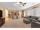 Open living room with grey sofa and carpet flooring at 16225 N 22Nd Dr, Phoenix, AZ 85023