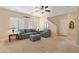 Living room with grey sofas and a ceiling fan at 16225 N 22Nd Dr, Phoenix, AZ 85023