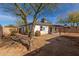 Backyard view of single story home with covered patio and detached garage at 1743 W Verde Ln, Phoenix, AZ 85015