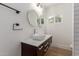 Bathroom with dark vanity, modern sink, and round mirrors at 1743 W Verde Ln, Phoenix, AZ 85015