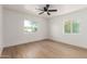 Spacious bedroom with light wood flooring and ceiling fan at 1743 W Verde Ln, Phoenix, AZ 85015