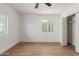 Bright bedroom with wood flooring, large closet, and window at 1743 W Verde Ln, Phoenix, AZ 85015