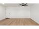 Simple bedroom with wood-look flooring and door at 1743 W Verde Ln, Phoenix, AZ 85015