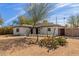 Updated home with modern facade and xeriscaped front yard at 1743 W Verde Ln, Phoenix, AZ 85015