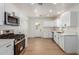 Newly renovated kitchen featuring white shaker cabinets and stainless steel appliances at 1743 W Verde Ln, Phoenix, AZ 85015